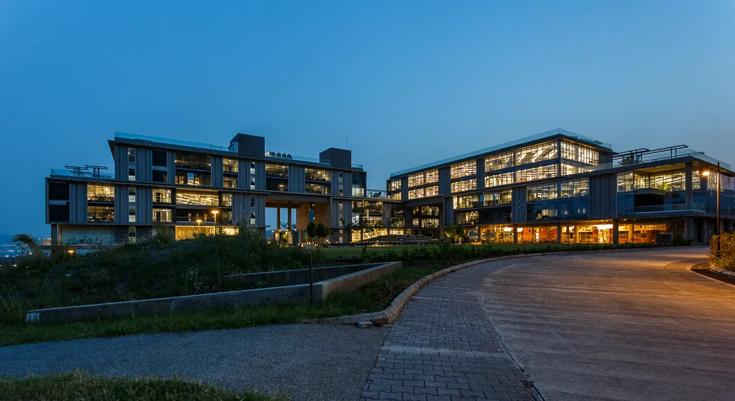 Office campus lit up at dusk